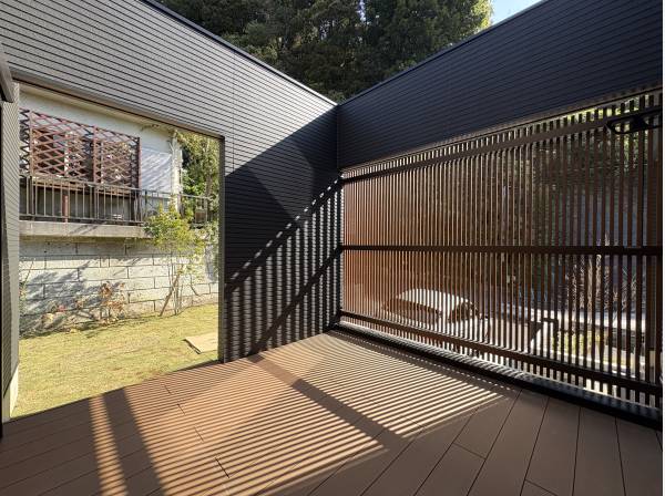 お庭とウッドデッキを囲うように配置された家