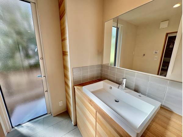 洗面台は広くて、隣には外に出られるように勝手口がありますよ！