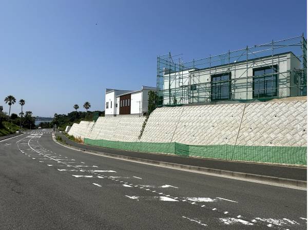 反対側から見た現地/抜け感はご覧の通りです/交通量の少ない道路