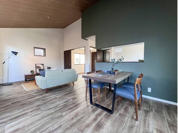 モスグリーンのキッチンのクロスにダイナミックな板張り天井がマッチ