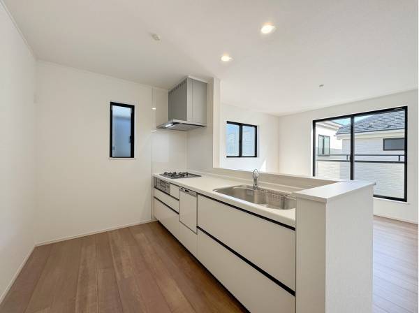 食洗機付きのシステムキッチンは白基調で清潔感がありますね