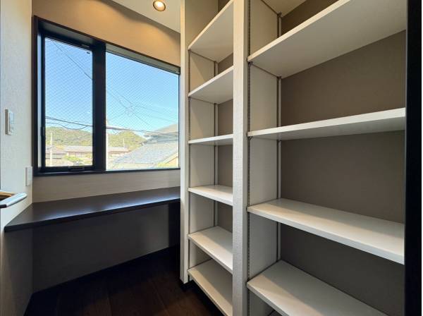 収納棚とカウンターデスク付きの多目的スペース。