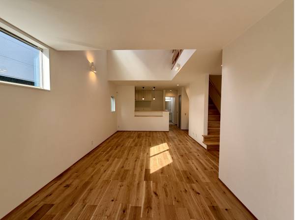 吹き抜けから光が差し込む、開放感を感じるリビング