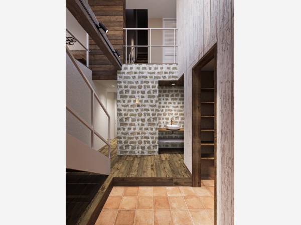 光が降りそそぐ大空間。古材と石壁が家族を迎える玄関。